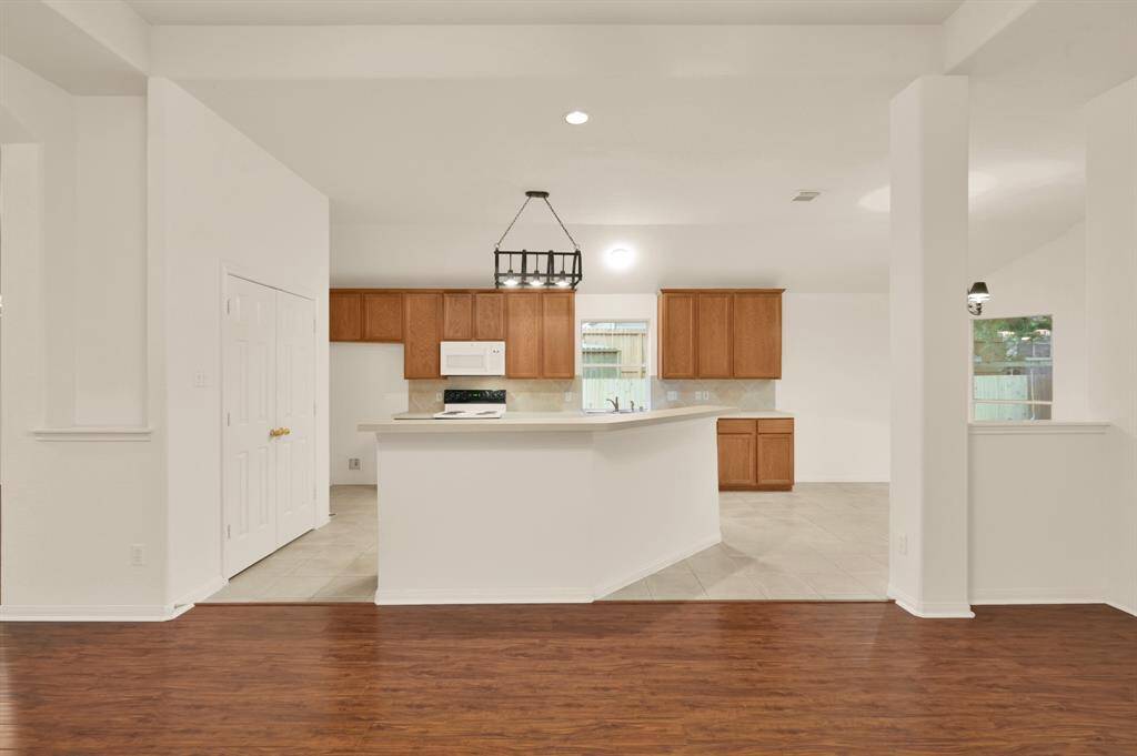 Open floor plan with a view into the kitchen, with a large island breakfast bar.