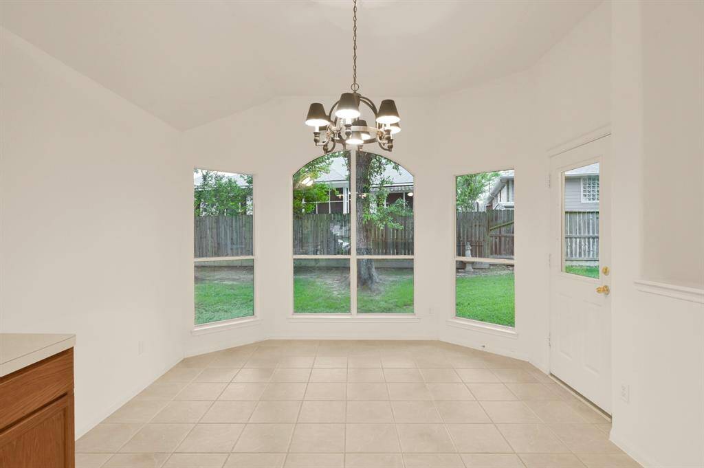 A generous amount of space in the light-filled breakfast room, with access to the covered back patio.