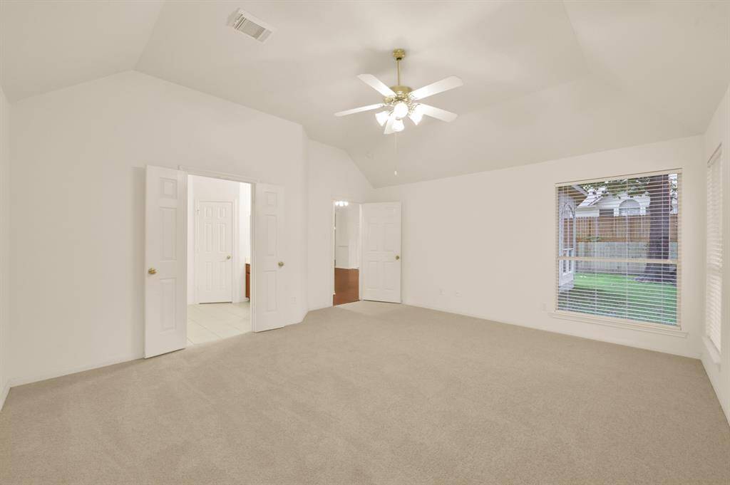 Double doors lead into the master en suite bathroom.