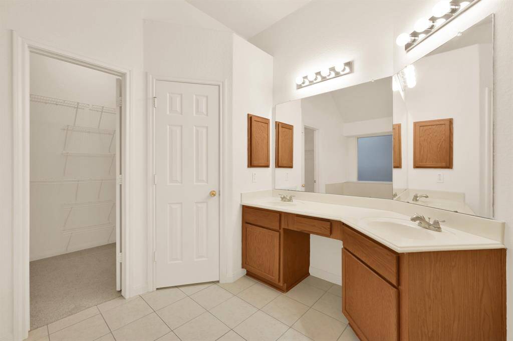 Double sinks and water closet. New ceramic tile in all bathrooms May 2025.
