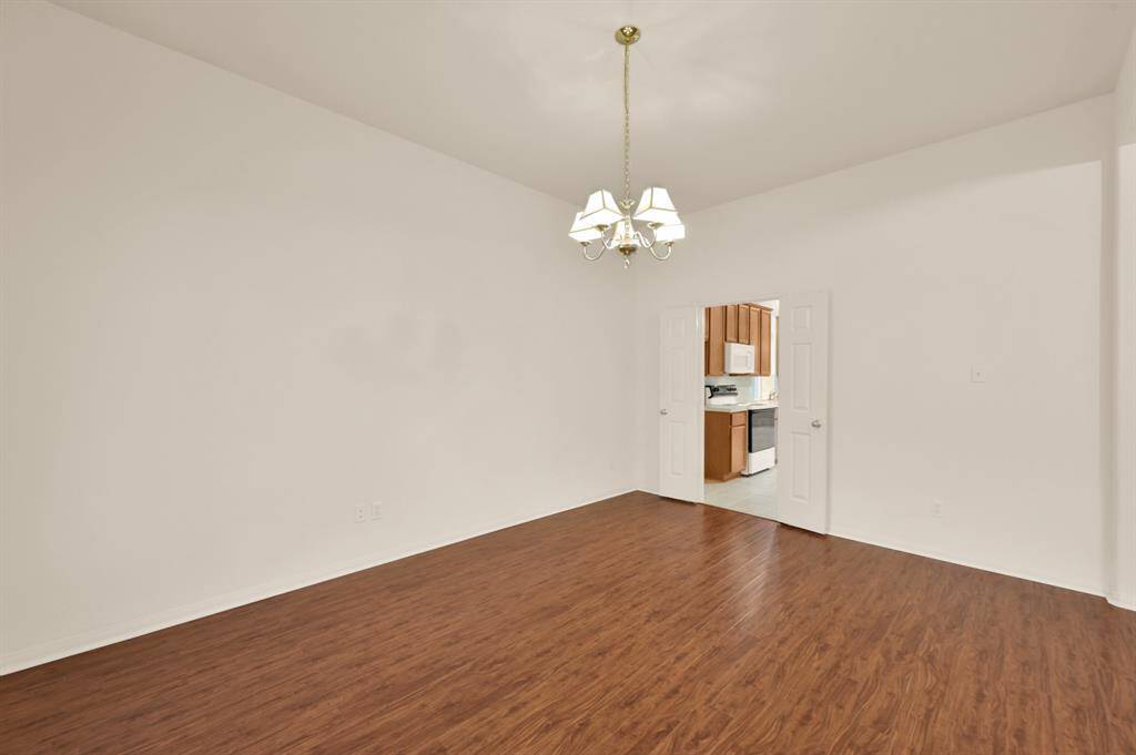 Dining room with double doors into the kitchen.