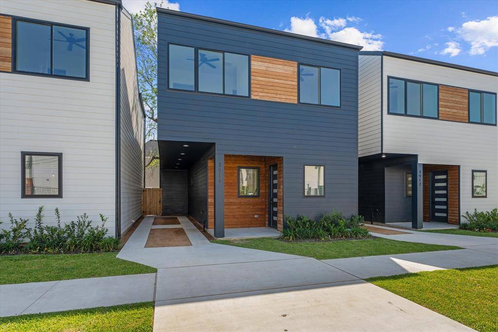 Exterior: Front. Home is in the center. Complete with wood features, deep driveway, with gated and fenced back yard.