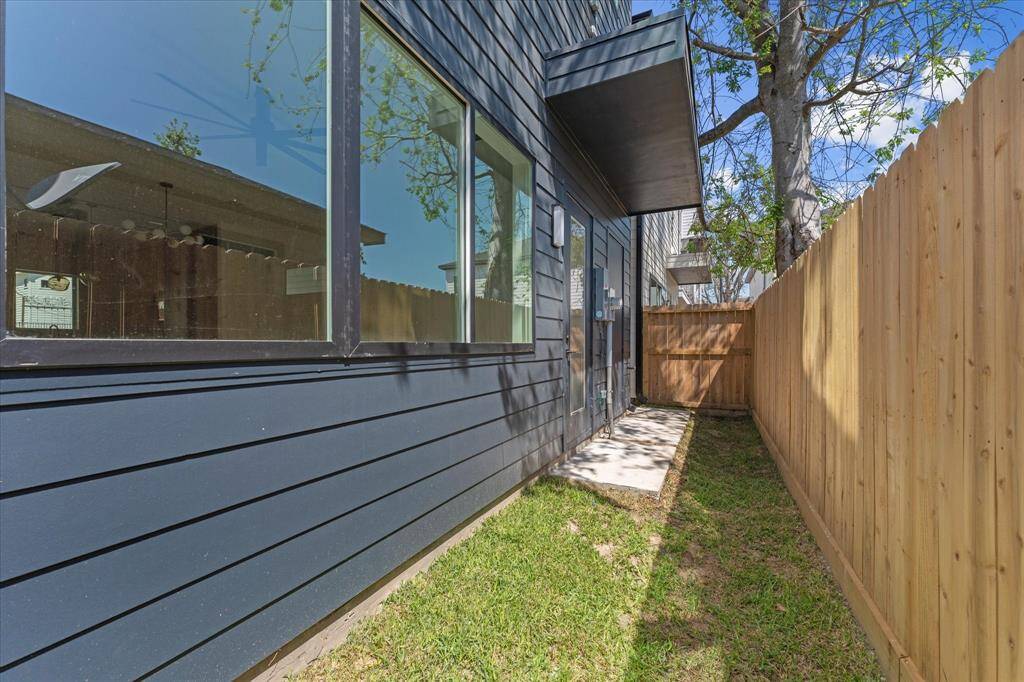 Exterior: Rear: Green space with elevated A/C unit and access to the CLIMATE CONTROLLED STORAGE ROOM!!!