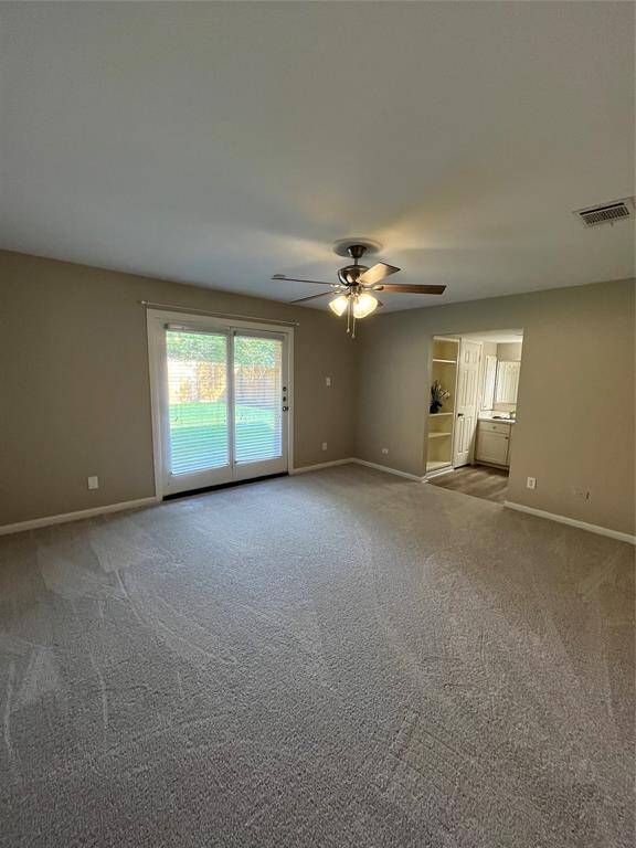 Primary Bedroom with ceiling fan and new carpet!