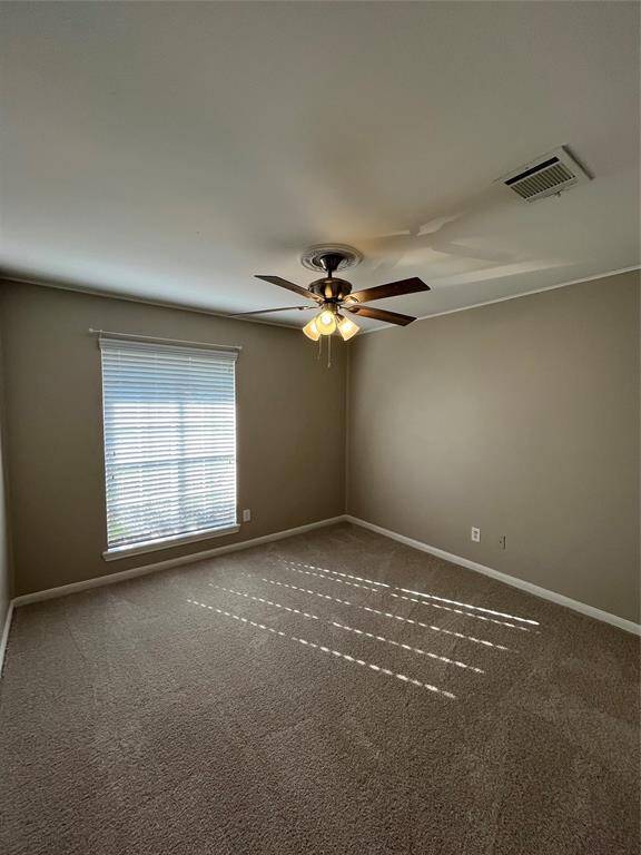 Second bedroom with ceiling fan and new carpet!