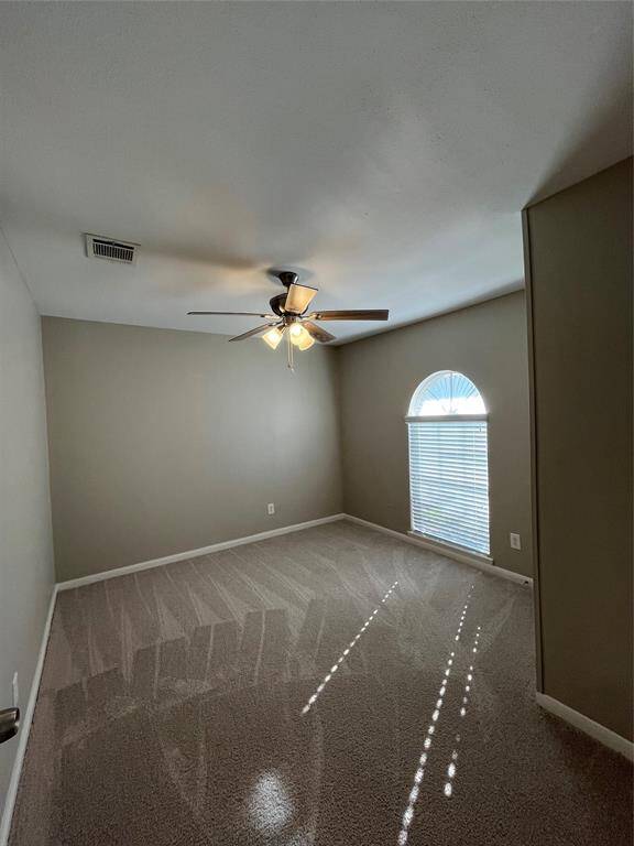 Third bedroom with ceiling fan and new carpet!