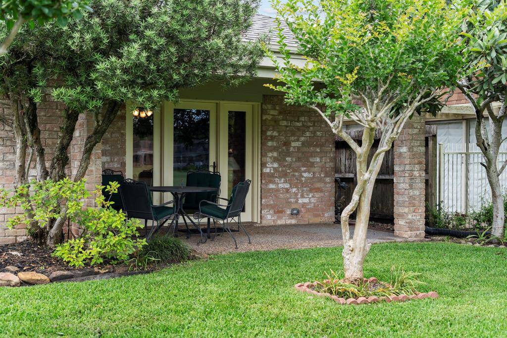 The covered back patio offers a comfortable outdoor retreat year-round, allowing you to relax while sheltered from sun and rain.