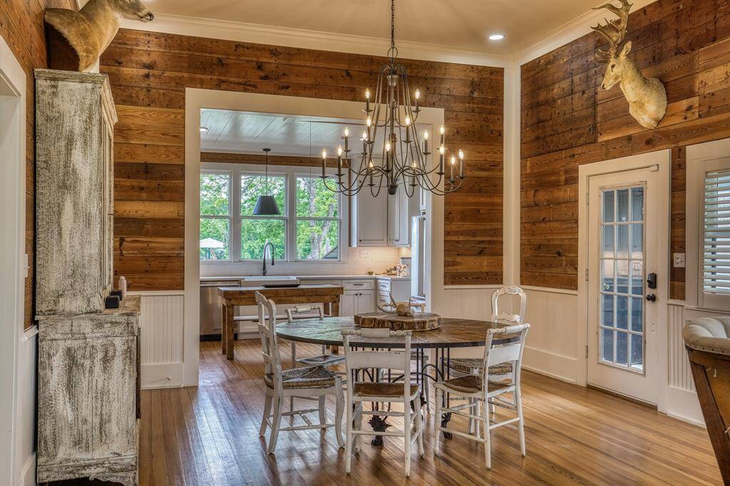 A seamless transition from kitchen to dining offers the ideal space for gathering. Warm wood tones, vintage textures, & a statement chandelier set the tone for meaningful meals & conversation.
