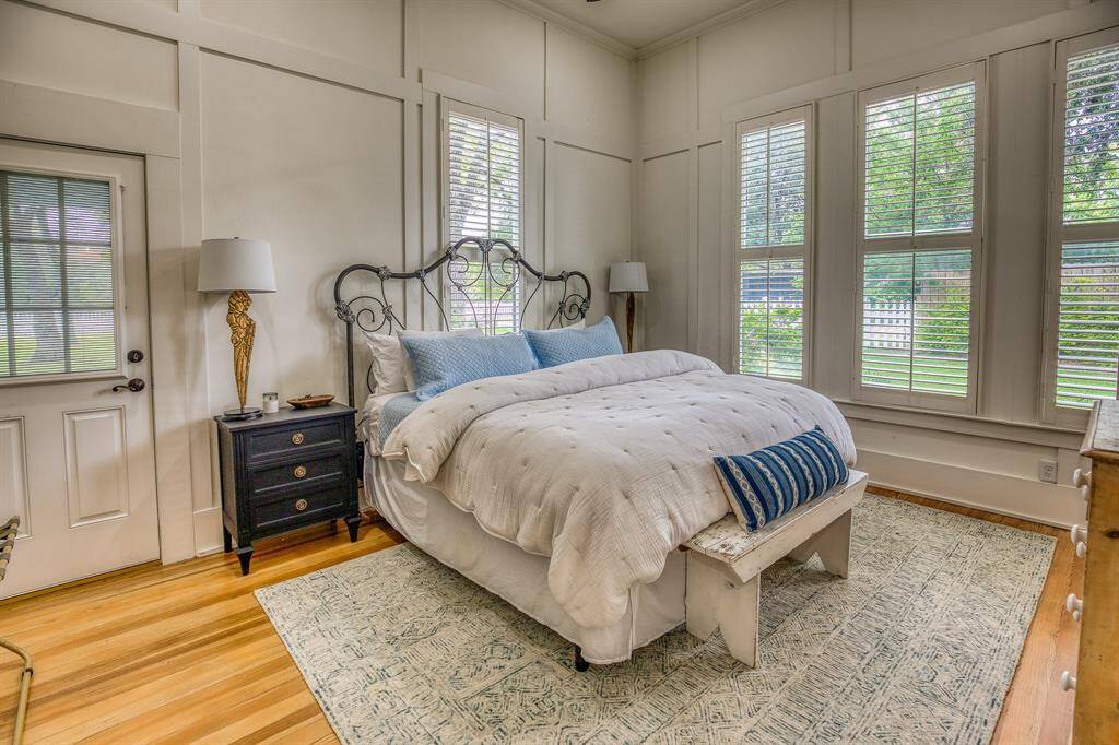 Historic millwork and oversized windows create the perfect background in The Cottontail's primary suite—ideal for slow mornings and midday naps. Enjoy direct access to the grounds from the privacy of this primary retreat.