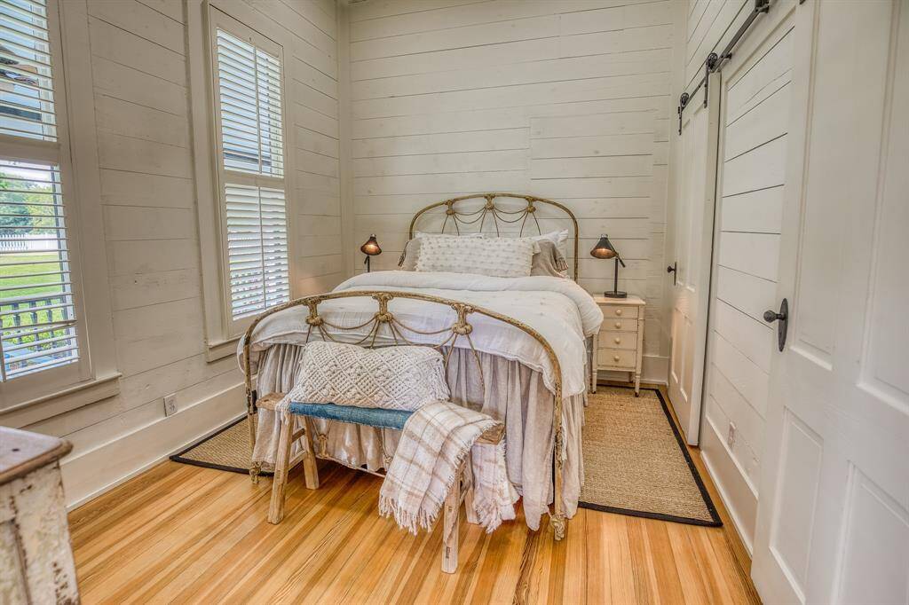 The second bedroom in The Cottontail blends modern wood flooring with layered textures and calming neutral tones—equal parts nostalgic and serene.
