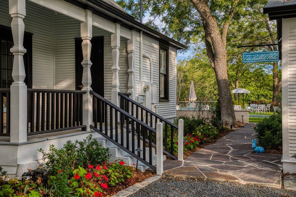 Follow the stone path to uncover the entrance to The Rabbit Hole—an inviting space designed for unforgettable gatherings.