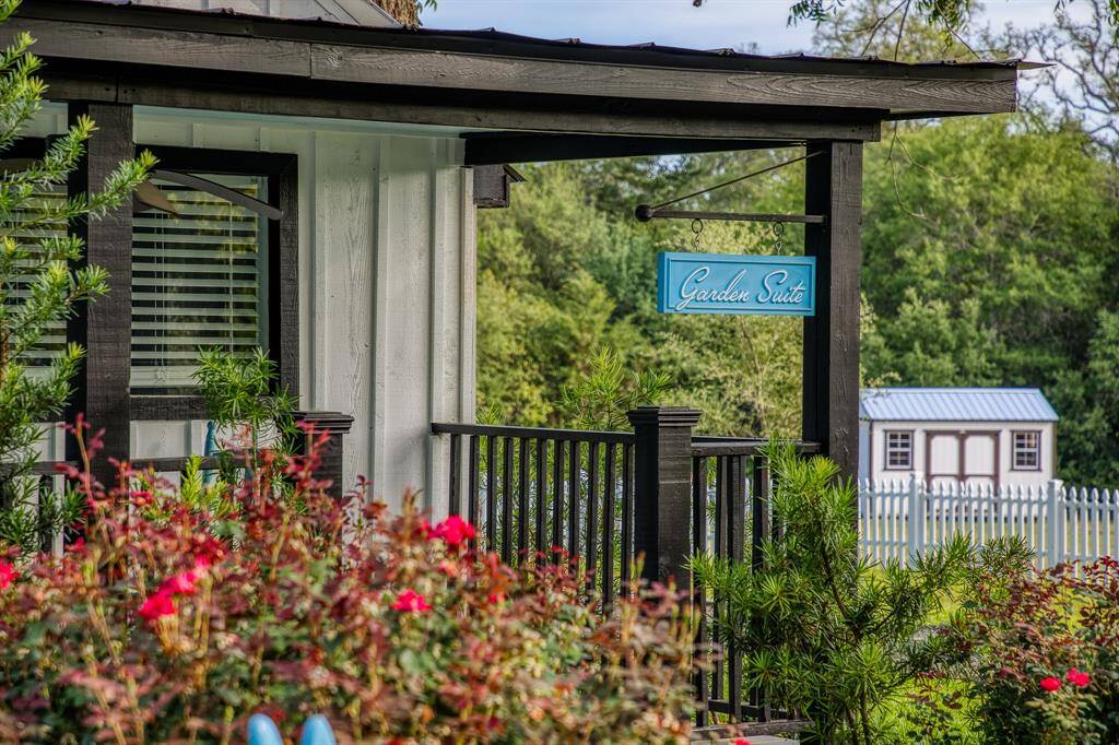 Framed by lush greenery, this cottage-style suite offers a picture-perfect porch and a warm Southern welcome.
