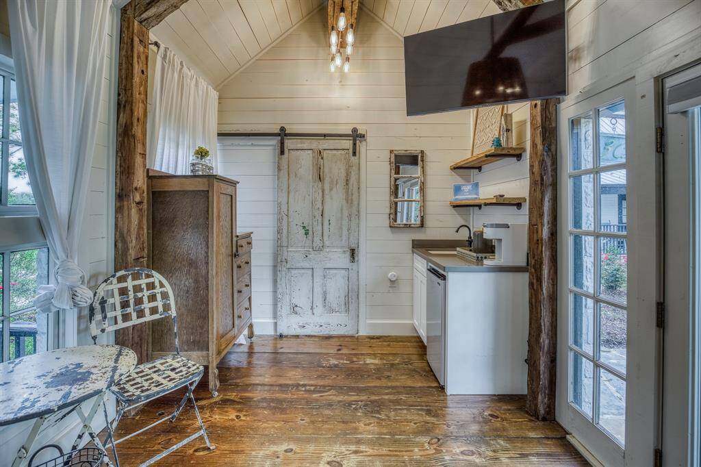 A charming kitchenette and weathered barn door give this cozy nook farmhouse flair, while offering all the essentials for a comfortable stay.