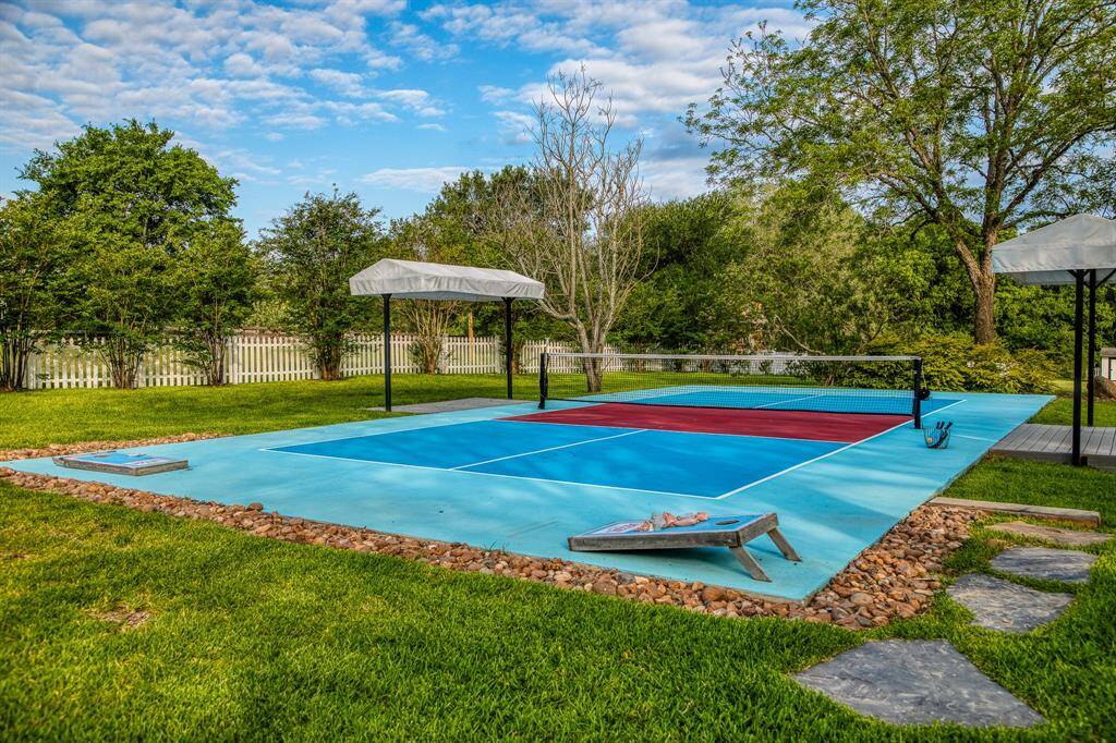 At the far end of the property, the private pickleball court stands ready for a friendly match or an afternoon rally. It’s a playful touch that elevates this estate beyond expectation.