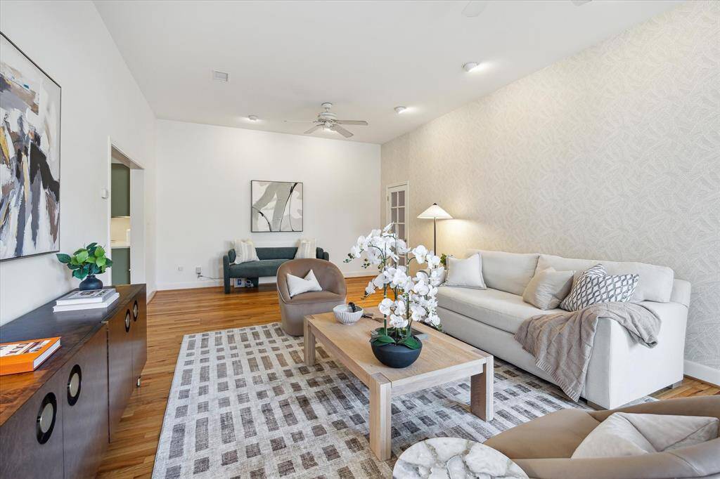 In the back right, there is a glass-paned door that leads to a staircase to the primary suite. There is also another door leading to the backyard.