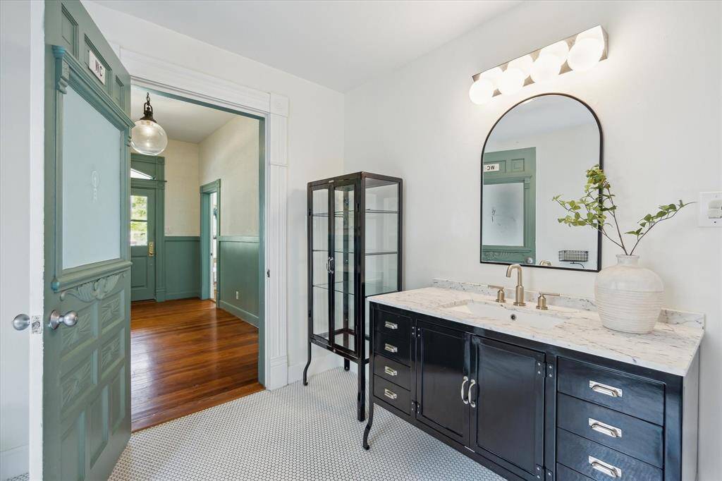 The original front door of 406 Archer was restored and is now the door to the bathroom! A wonderful way to keep the original charm while adding functionality!