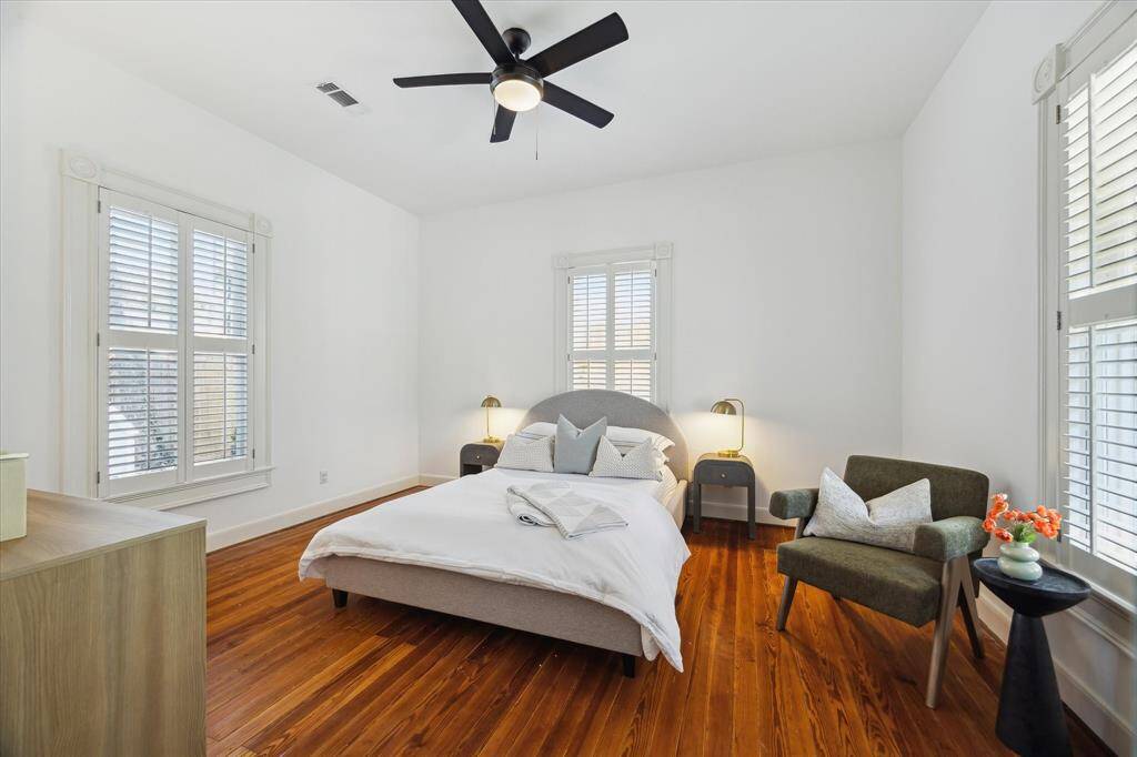 Another perspective of second secondary bedroom. Ceiling fan and plantation shutters