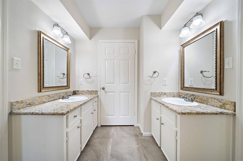 Jack and Jill bathroom with separate vanities and shower room.