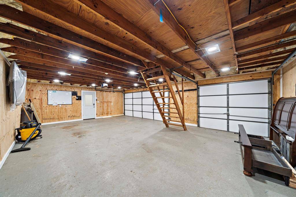 Fully insulated 3-car garage with upstairs storage.