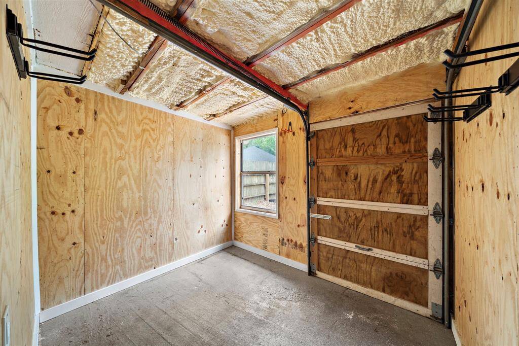 Storage/Garden shed with backyard rolling door access.