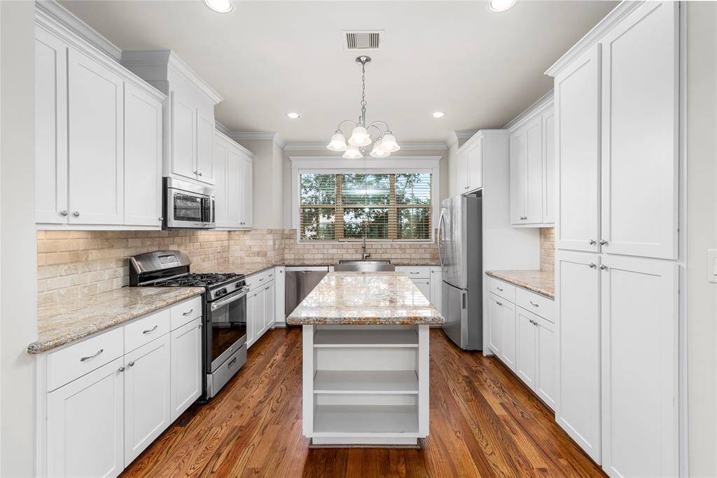 Kitchen-Windows for natural light. Granite countertops. Stainless steel appliances included. Farmhouse sink. Brick/stone backsplash.