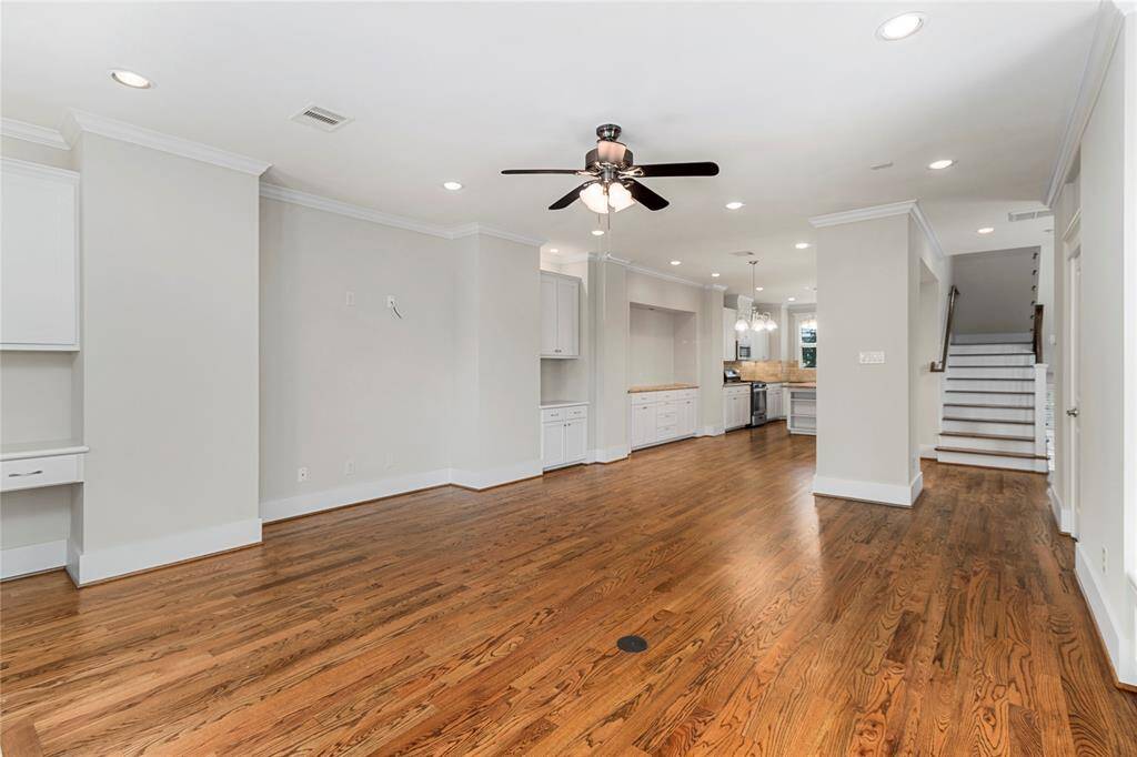 2nd floor-Living room view into Dining Room & Kitchen. Staircase leading up the 3rd floor.