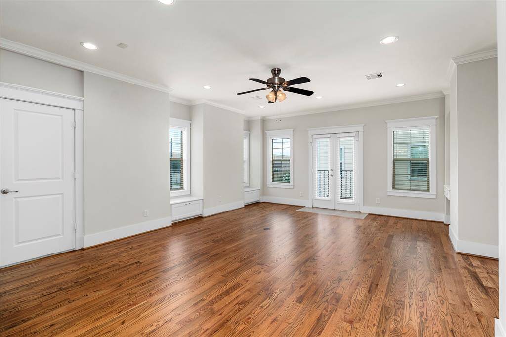 Living Room-Built-in benches with storage drawers below offer seating and functionality. French doors open to Juliet Balcony adding charm and enhancing natural light.