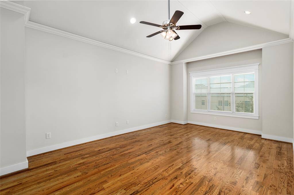 Primary bedroom located on 3rd floor offers abundant natural light through multiple windows, recessed lighting, crown molding, rich hardwood flooring and tall ceilings for an airy elevated feel.
