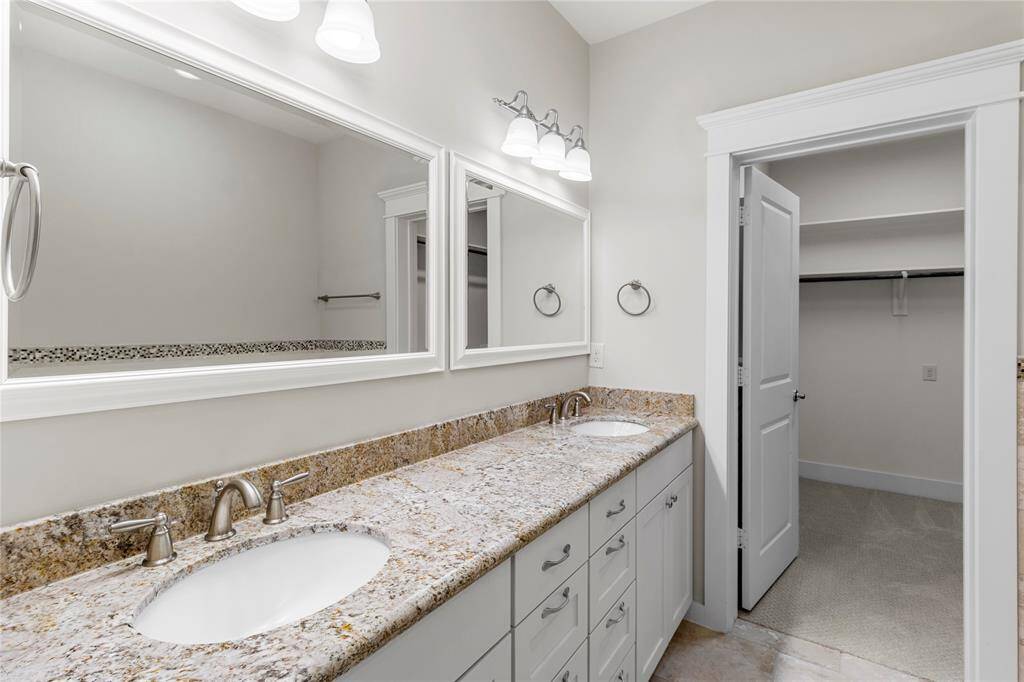 Primary Bathroom features double sinks with multiple drawers for abundant storage.