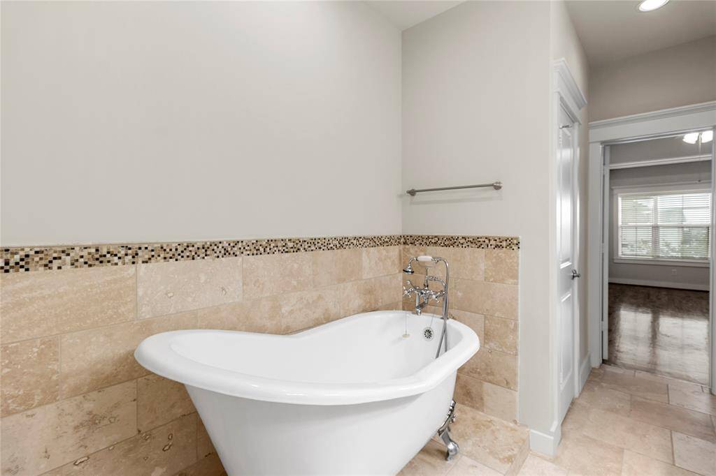 Luxurious clawfoot tub in Primary Bathroom.