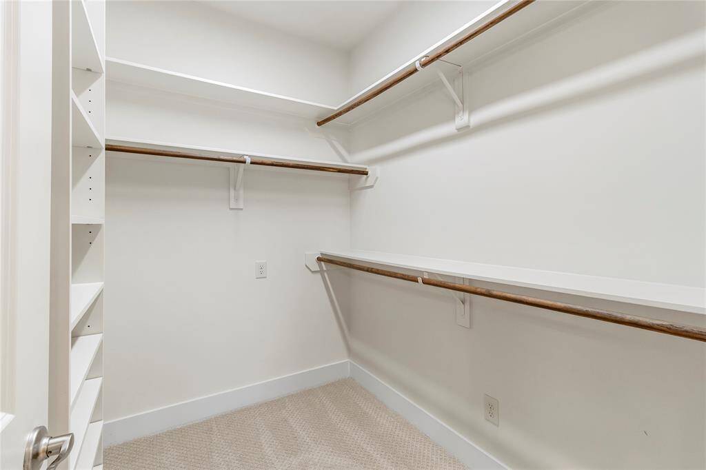 Primary Bedroom Closet-Generous sized closet with ample hanging space and custom built-in shelves and drawers.