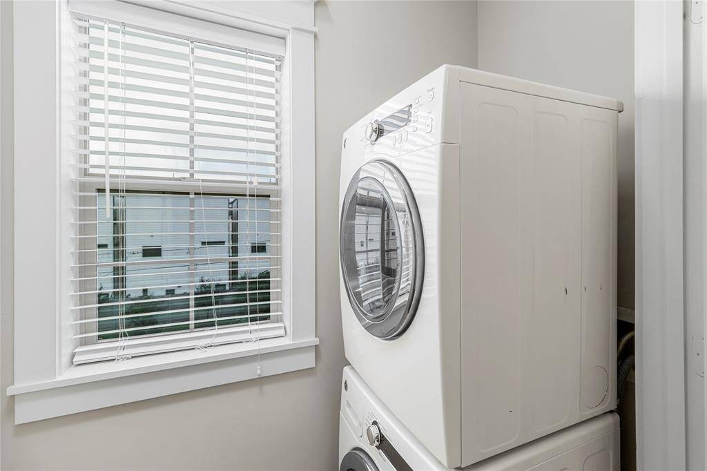Utility Room-Located on 3rd floor. Offers natural light through a large window in this well-designed efficient space. Front-loading stackable washer and dryer included.