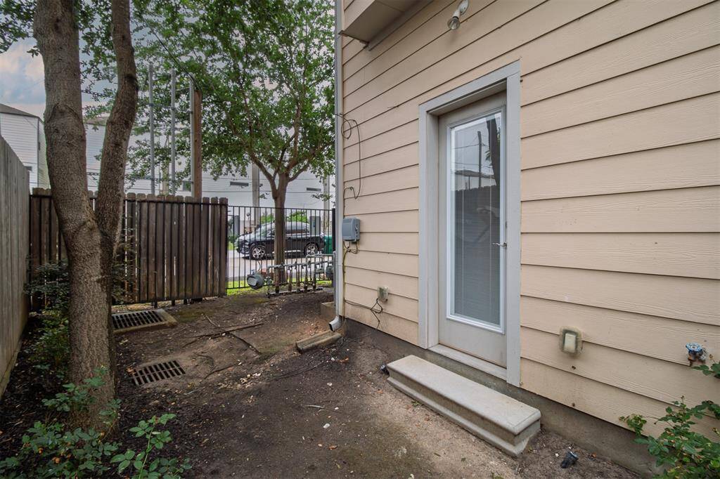 Fully Fenced Side Yard-Offers privacy and potential-Ready for sod and landscaping to create an outdoor retreat. Exterior door enters into 1st Floor Bedroom.
