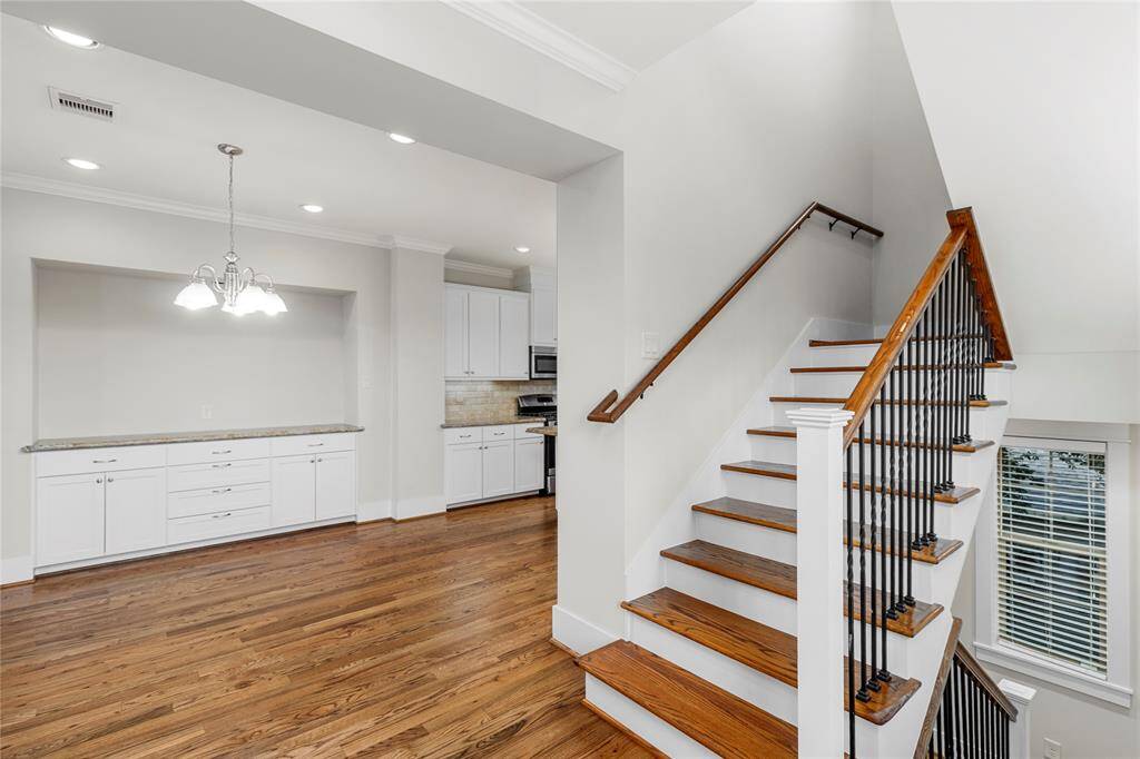 2nd floor-Dining area with storage & bar area. Stairs leading up to 3rd floor.