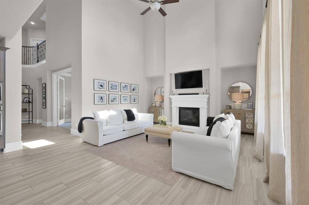 This home boasts soaring two-story ceilings and a wall of windows offering an abundance of natural light and views of the backyard oasis!