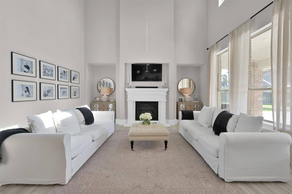 This home boasts soaring two-story ceilings and a wall of windows offering an abundance of natural light and views of the backyard oasis!