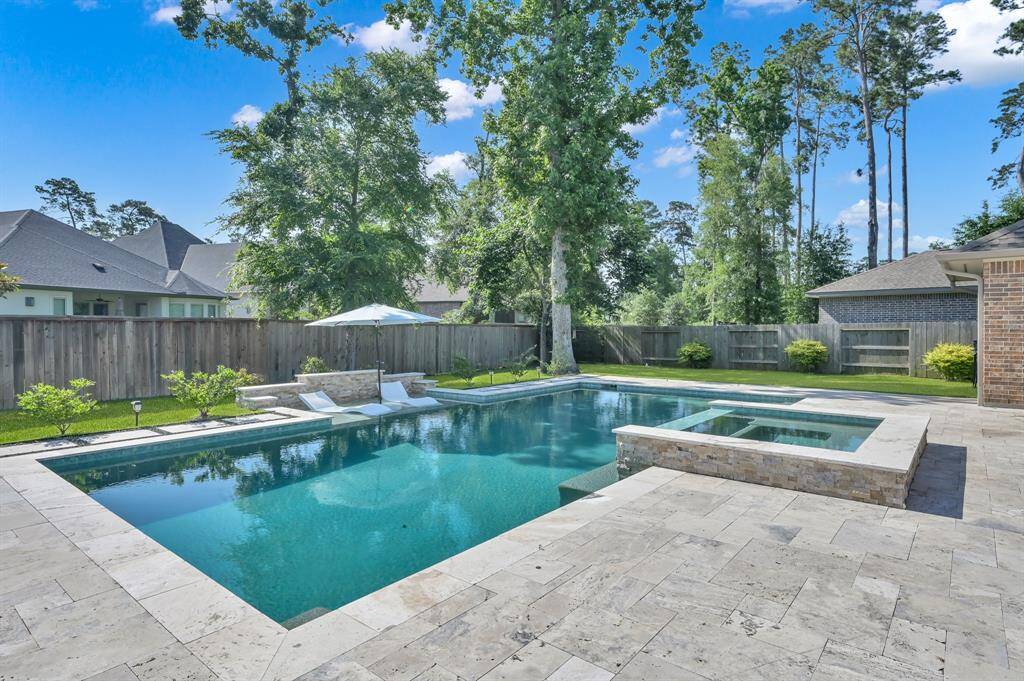 Featuring a luxurious pool and spa with travertine decking, this home offers outdoor living that outshines new construction.