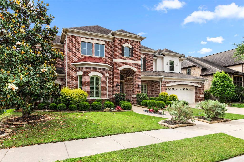 Beautiful curb appeal with meticulously kept landscaping and front lawn welcomes you to this special property.