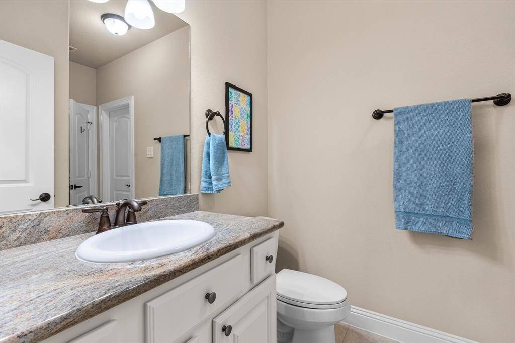 This bathroom off of the bedroom also provides an access door to a hallway for the gameroom and media room.
