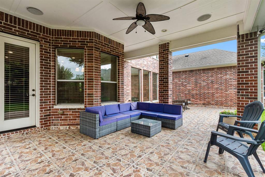 Outside there's a huge patio with tiled floor. A large portion of this patio is covered and there is a continuation of the patio that is open. The best of both worlds.