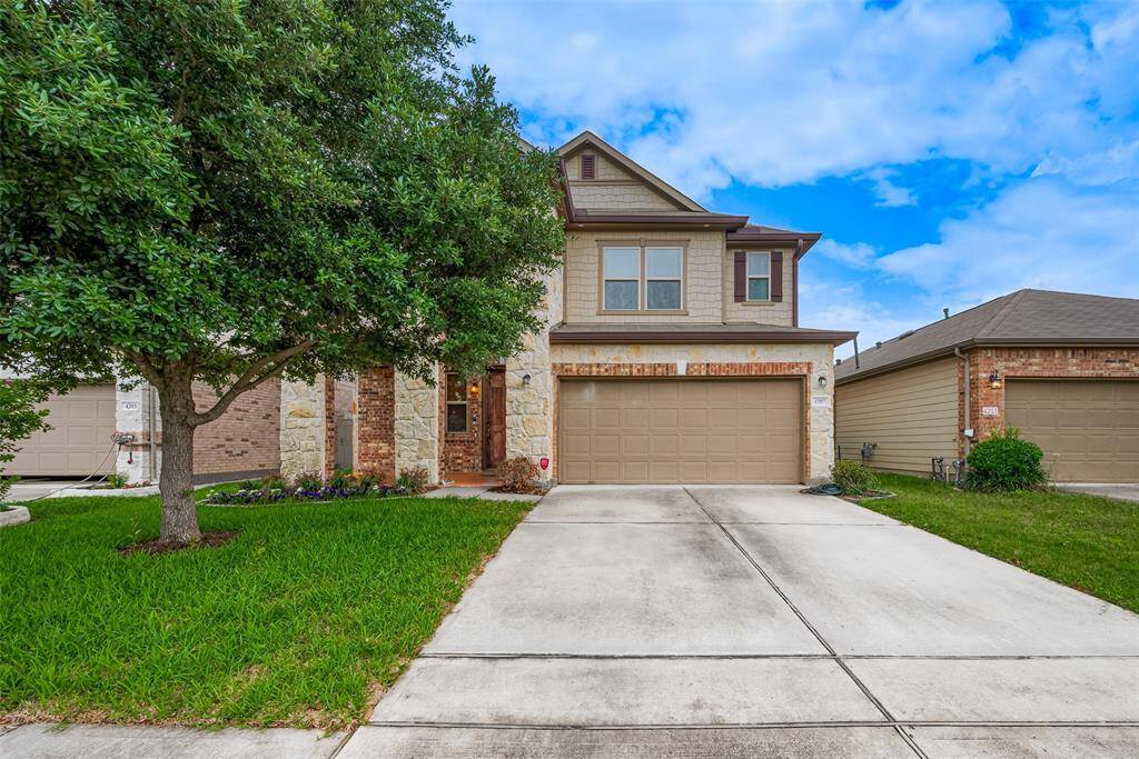Charming two-story home with a brick facade and attached two-car garage. Features a well-maintained lawn, mature tree, and a welcoming entrance. Ideal for families seeking a cozy neighborhood setting.