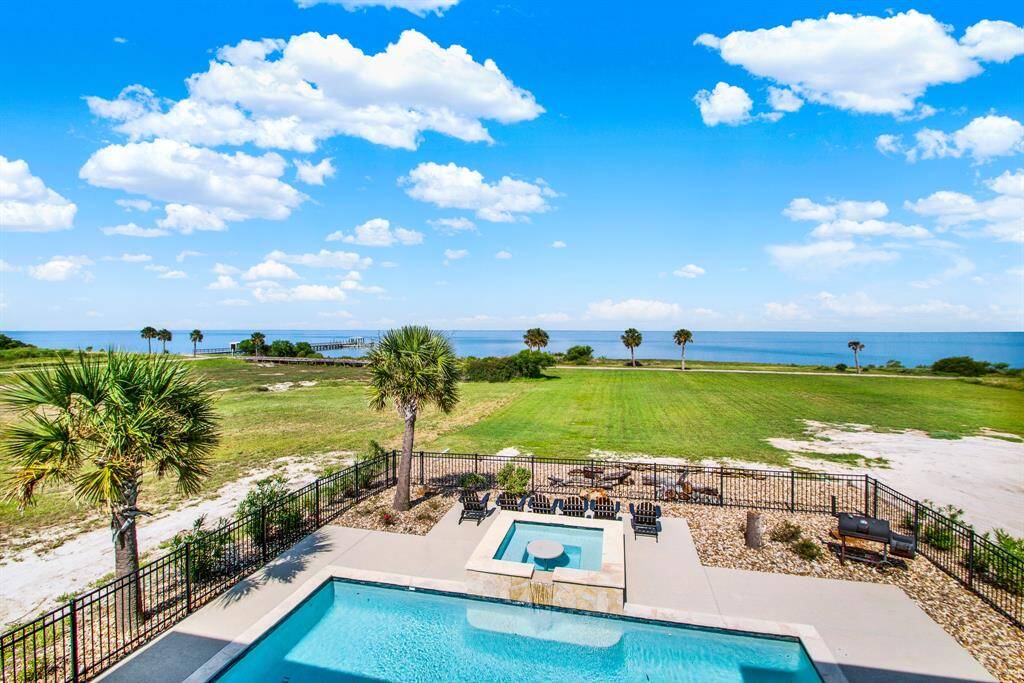 This property offers a stunning ocean view with a backyard oasis and ample outdoor living space that is perfect for all to enjoy the serene environment.