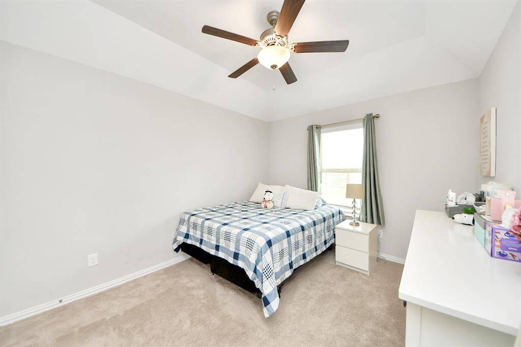 Bedroom #2 has lots of natural light, high ceilings and a ceiling fan.