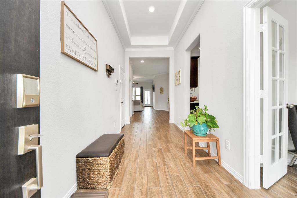 As you enter the home, you will notice the warm wood-like tile flooring and high ceilings.