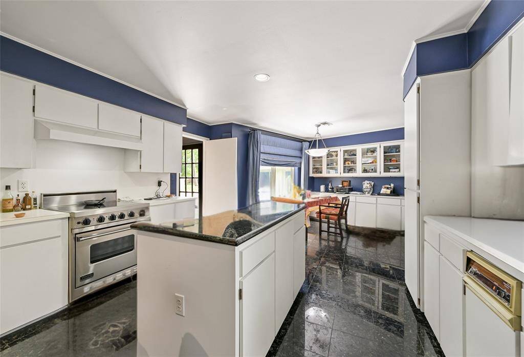 This functional kitchen offers a center island, ample storage, and seamless flow into the breakfast room—ideal for everyday living.