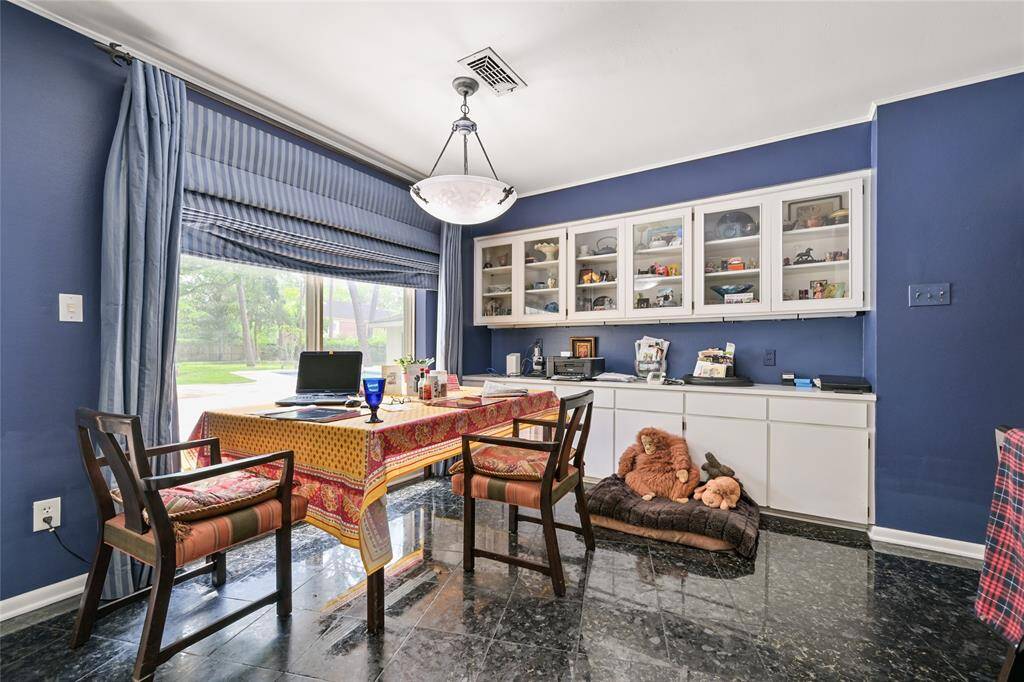 Enjoy morning coffee or casual meals in this cheerful breakfast room with built-ins, backyard views, and natural light that floods the space.