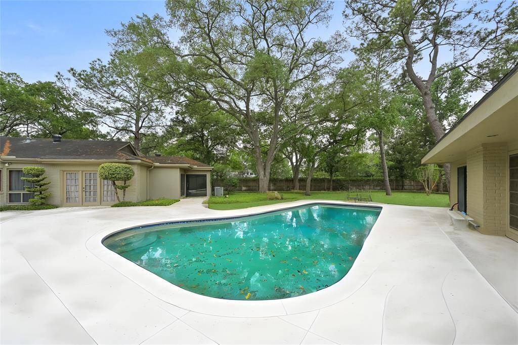 Enjoy serene views and peaceful moments from this beautifully maintained backyard, complete with a generous pool deck, manicured lawn, and multiple lounging areas ideal for weekend gatherings.
