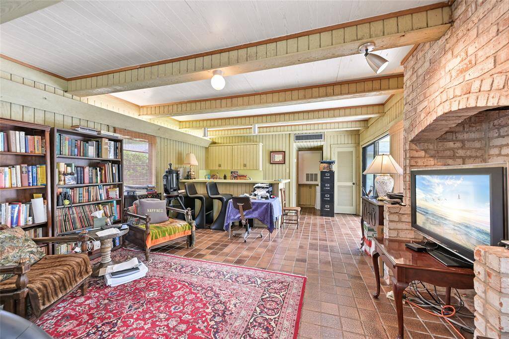 This inviting guest house features serene pool views, a cozy lounge area, and a convenient kitchenette with sink—perfect for entertaining or a personal retreat.