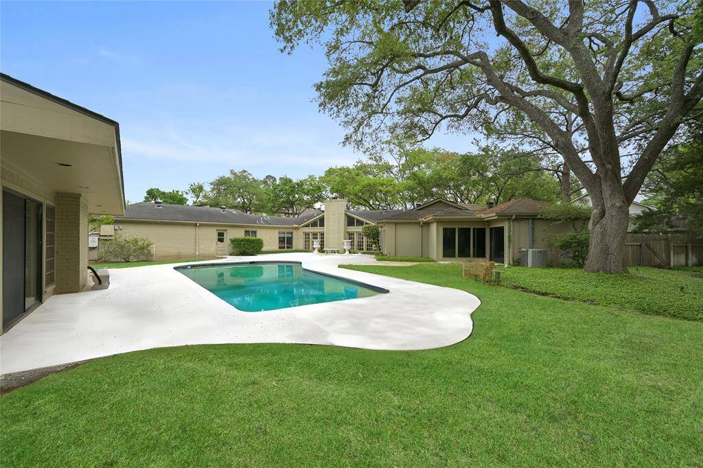 A tranquil, tree-lined backyard with a classic ranch-style charm—this backyard space is perfect for summer days, evening gatherings, and everything in between!