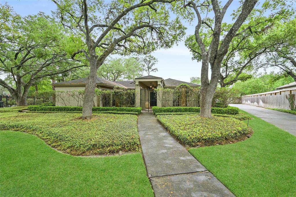 This over half-acre lot offers a park-like setting with curated landscaping and vibrant greenery—an ideal backdrop for serene everyday living.
